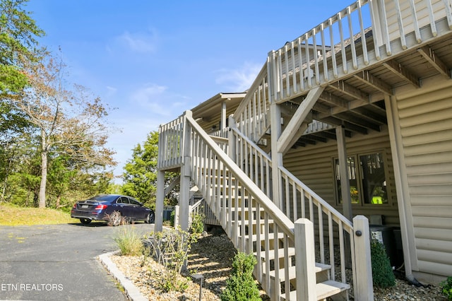 view of side of property featuring a wooden deck