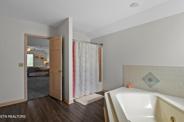 bathroom featuring a textured ceiling, wood-type flooring, lofted ceiling, ceiling fan, and shower with separate bathtub