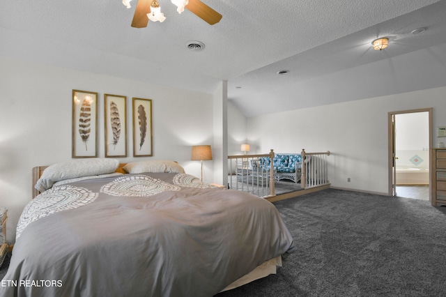 carpeted bedroom featuring ceiling fan, ensuite bathroom, vaulted ceiling, and a textured ceiling