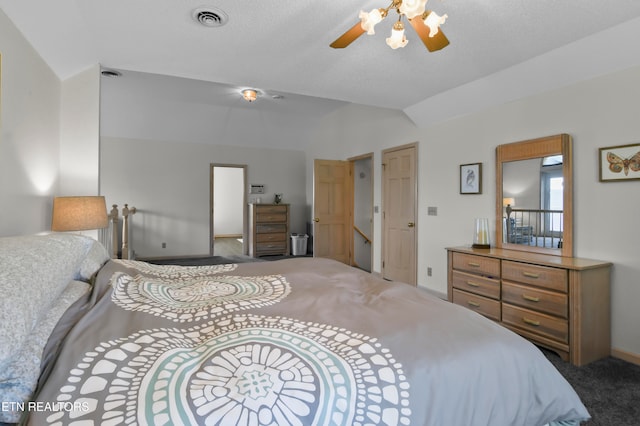 carpeted bedroom featuring lofted ceiling, ceiling fan, and a textured ceiling