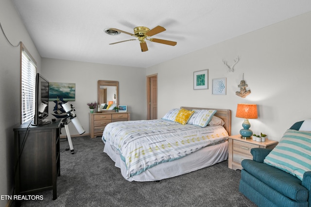 bedroom with dark colored carpet and ceiling fan