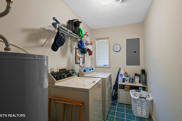 washroom with dark tile patterned floors, a textured ceiling, electric panel, washer and dryer, and water heater