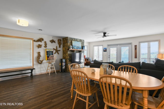 dining area with ceiling fan and dark hardwood / wood-style flooring