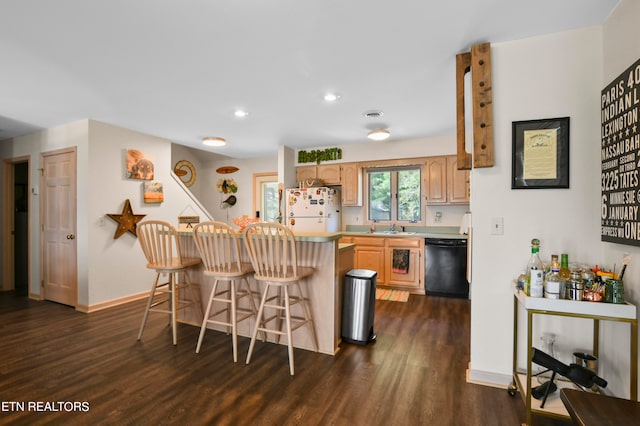 kitchen featuring a kitchen breakfast bar, black dishwasher, kitchen peninsula, white fridge, and dark hardwood / wood-style floors