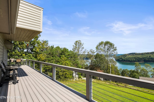 deck featuring a lawn and a water view