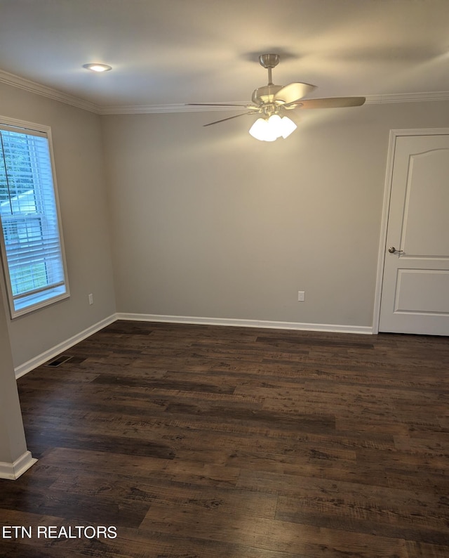 empty room with ornamental molding, dark hardwood / wood-style flooring, and ceiling fan