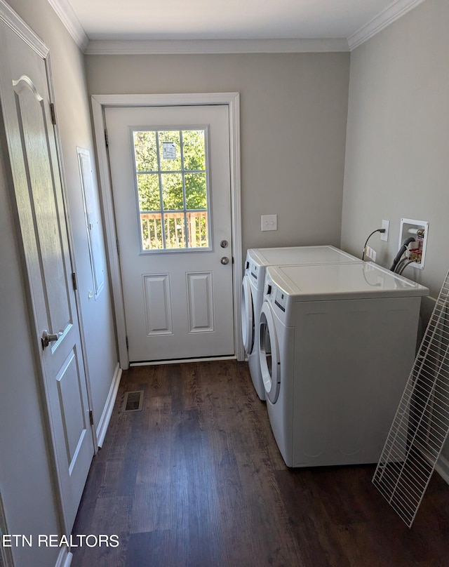 laundry room with ornamental molding, dark hardwood / wood-style floors, and washer and dryer