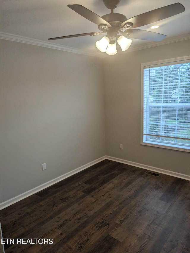 spare room with ceiling fan, crown molding, and dark wood-type flooring