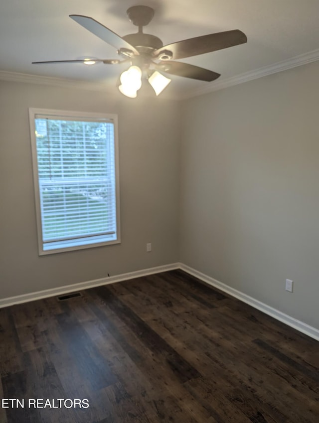 empty room with ceiling fan, dark wood-type flooring, and crown molding