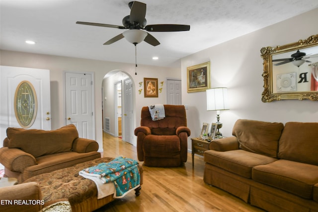 living room featuring ceiling fan and light wood-type flooring