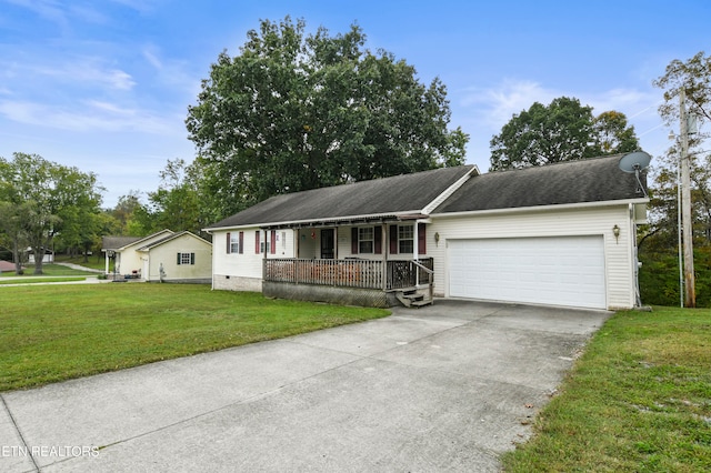 ranch-style house with covered porch, a front yard, and a garage