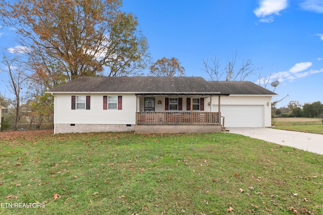 view of front of home with covered porch, a garage, and a front yard