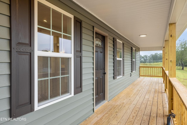 wooden terrace with a porch