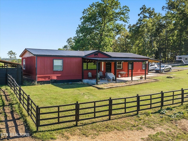 view of front of property with a patio area and a front lawn