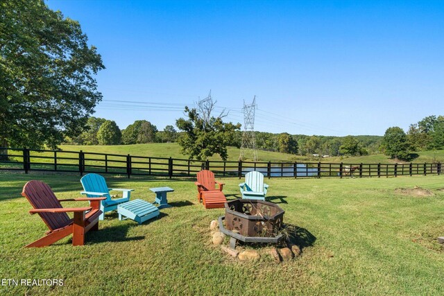 view of yard with a rural view and an outdoor fire pit