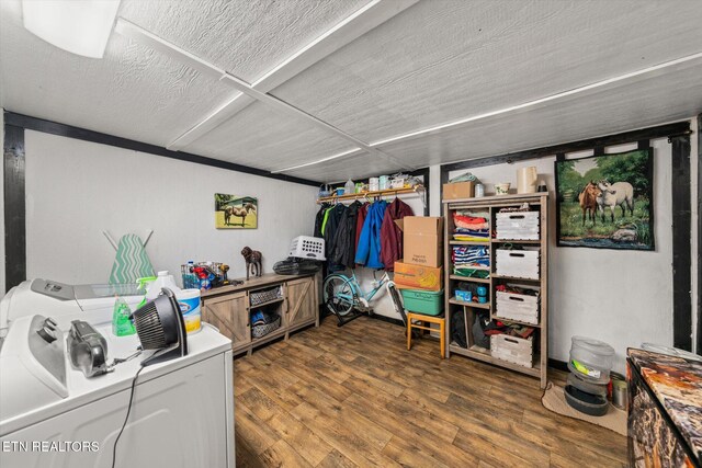 laundry room with a textured ceiling, dark hardwood / wood-style flooring, and washing machine and dryer