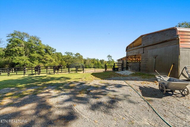 view of yard featuring an outbuilding and a rural view