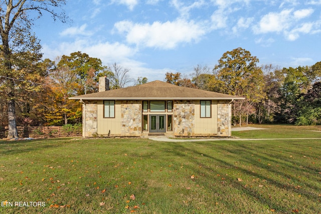 rear view of property featuring french doors and a yard