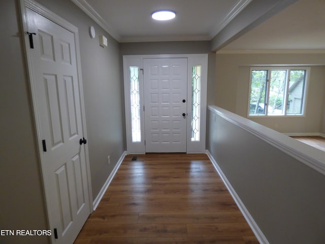 foyer entrance featuring crown molding and dark hardwood / wood-style floors