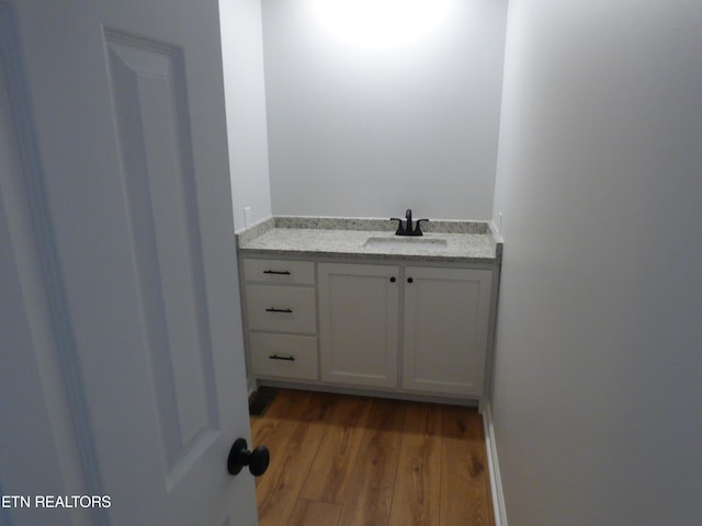 bathroom featuring vanity and hardwood / wood-style floors