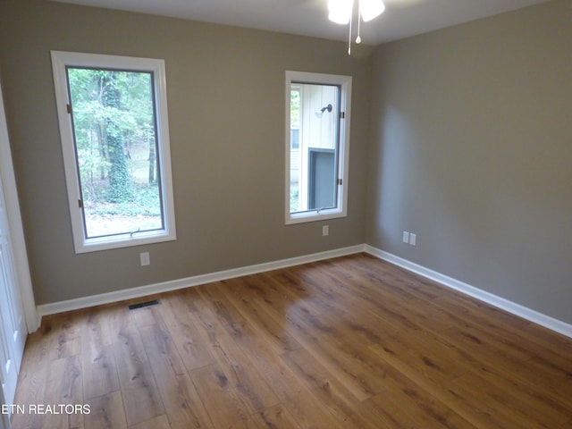 unfurnished room with ceiling fan, light hardwood / wood-style floors, and a wealth of natural light