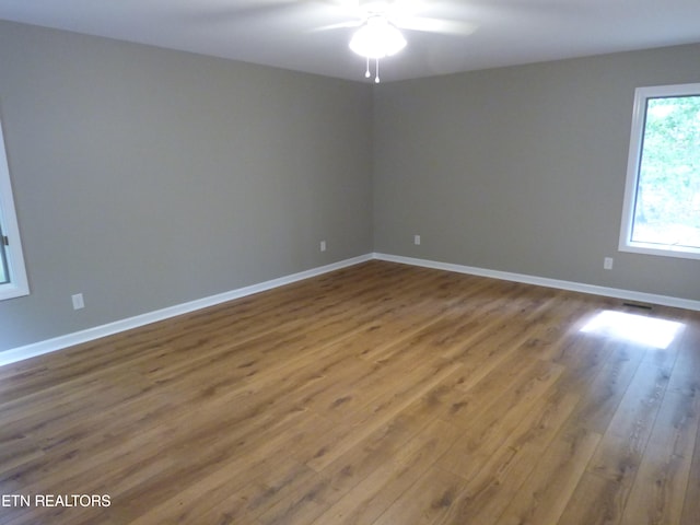 spare room featuring ceiling fan and hardwood / wood-style flooring