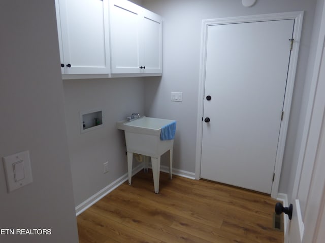 laundry area with washer hookup, cabinets, and hardwood / wood-style floors