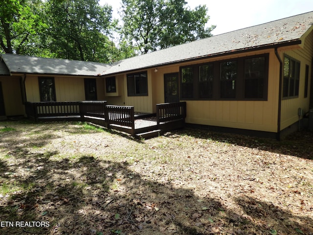 rear view of property with a wooden deck