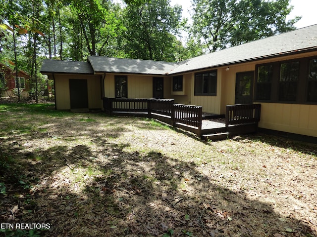 rear view of house with a wooden deck