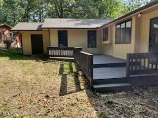 rear view of house featuring a deck