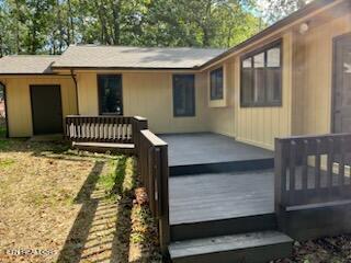 rear view of property with a wooden deck