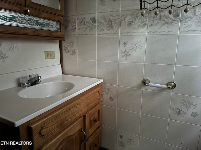 bathroom with vanity and tile walls