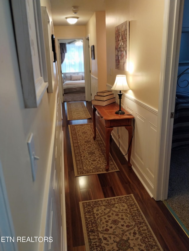 hall with dark hardwood / wood-style flooring