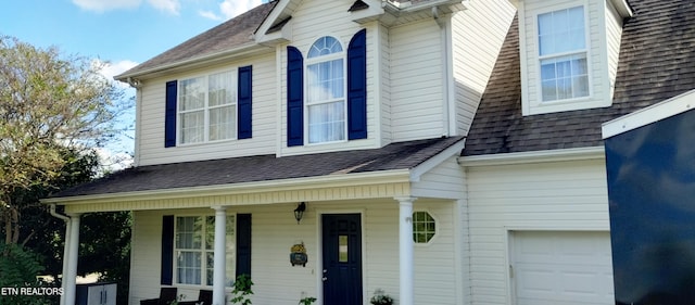 view of front of property featuring a garage and a porch