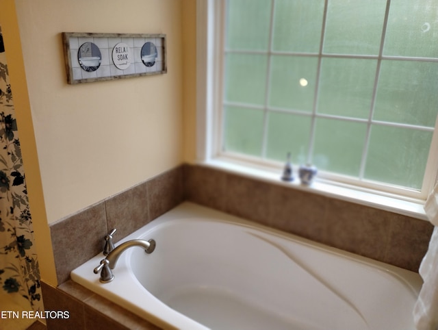 bathroom with tiled tub