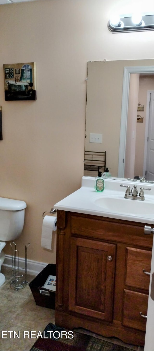 bathroom with vanity, toilet, and tile patterned floors