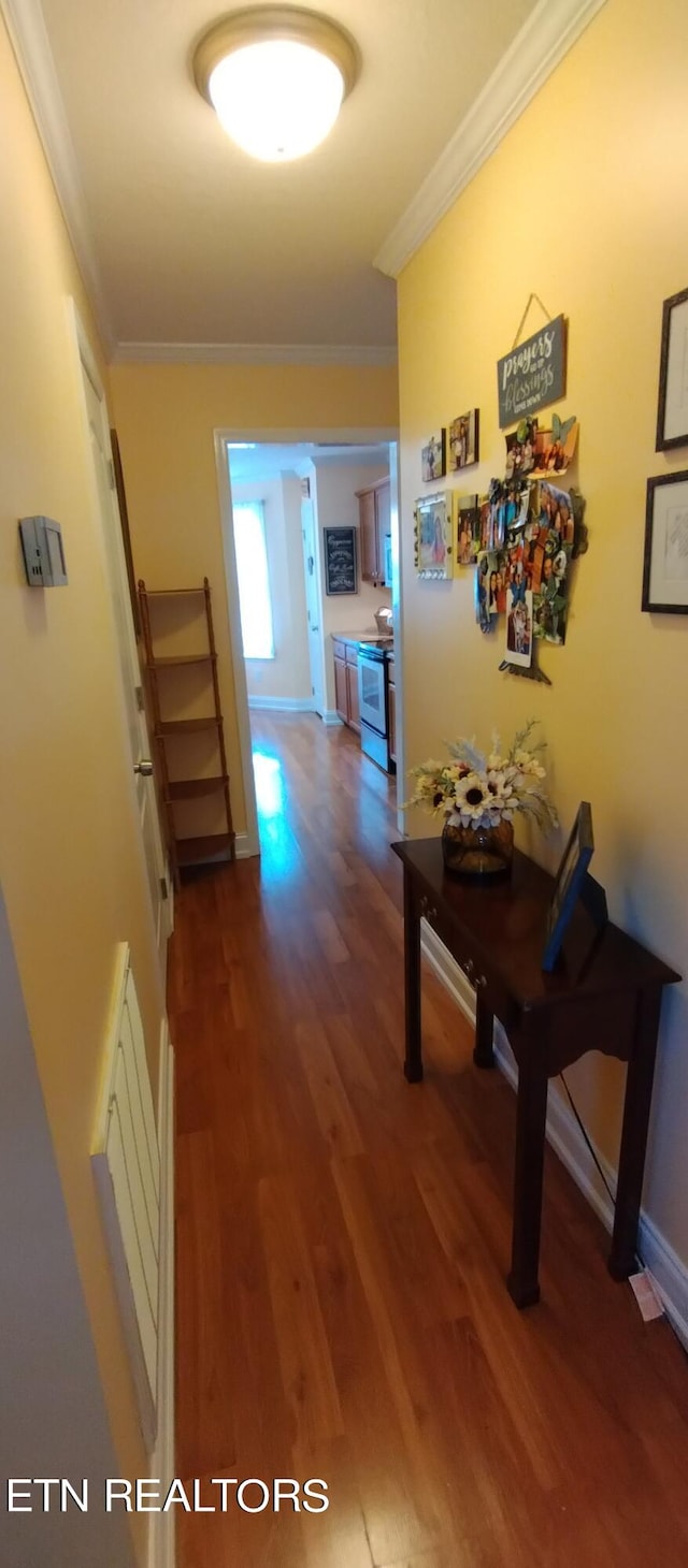 hall with ornamental molding and hardwood / wood-style flooring