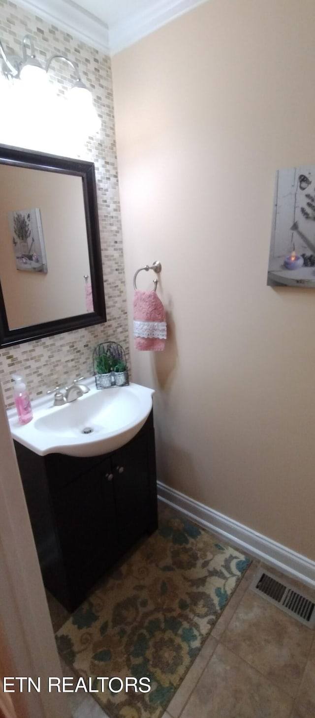 bathroom with crown molding, tasteful backsplash, vanity, and tile patterned floors