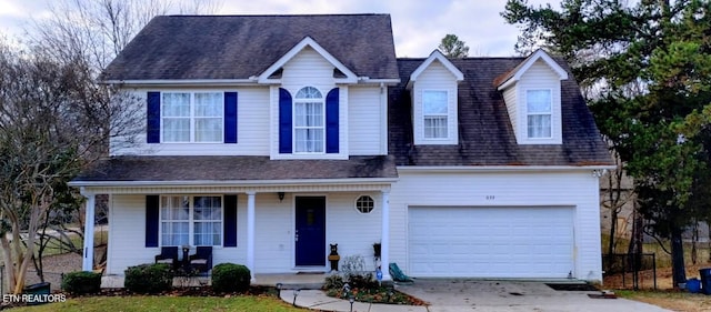 view of front of house featuring a garage and covered porch