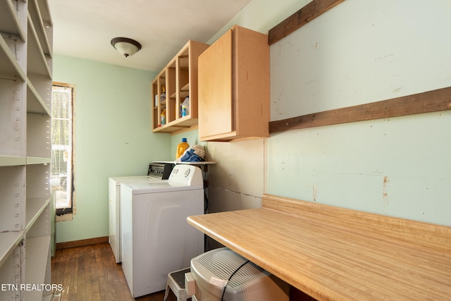 clothes washing area featuring washer / clothes dryer and dark hardwood / wood-style floors