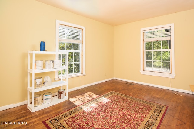 unfurnished room featuring hardwood / wood-style flooring