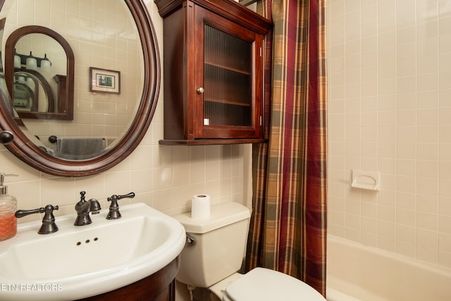 full bathroom featuring tile walls, tasteful backsplash, vanity, shower / tub combo with curtain, and toilet