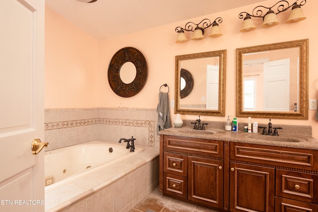 bathroom featuring vanity, tiled bath, and tile patterned floors