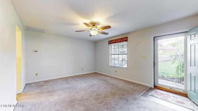 carpeted spare room with ceiling fan