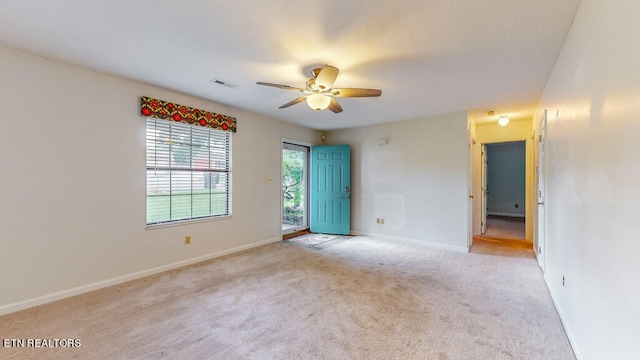 spare room with light colored carpet and ceiling fan