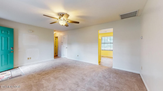 carpeted empty room featuring ceiling fan