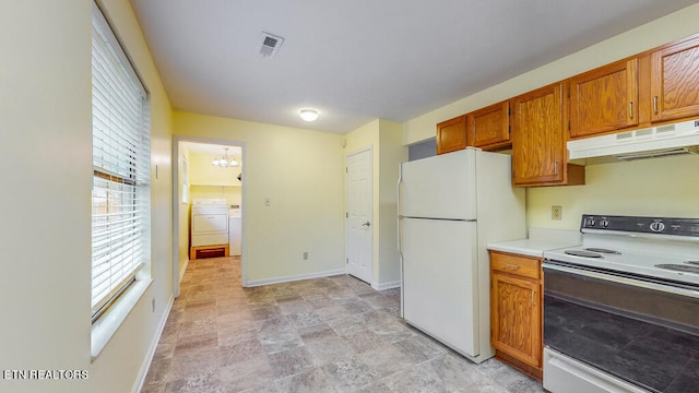 kitchen with white appliances and washing machine and dryer