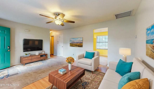 living room with hardwood / wood-style flooring and ceiling fan