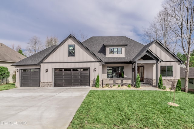 view of front of property featuring a front lawn, covered porch, and a garage