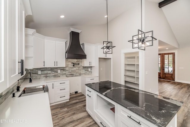 kitchen with premium range hood, sink, white cabinets, and dark wood-type flooring